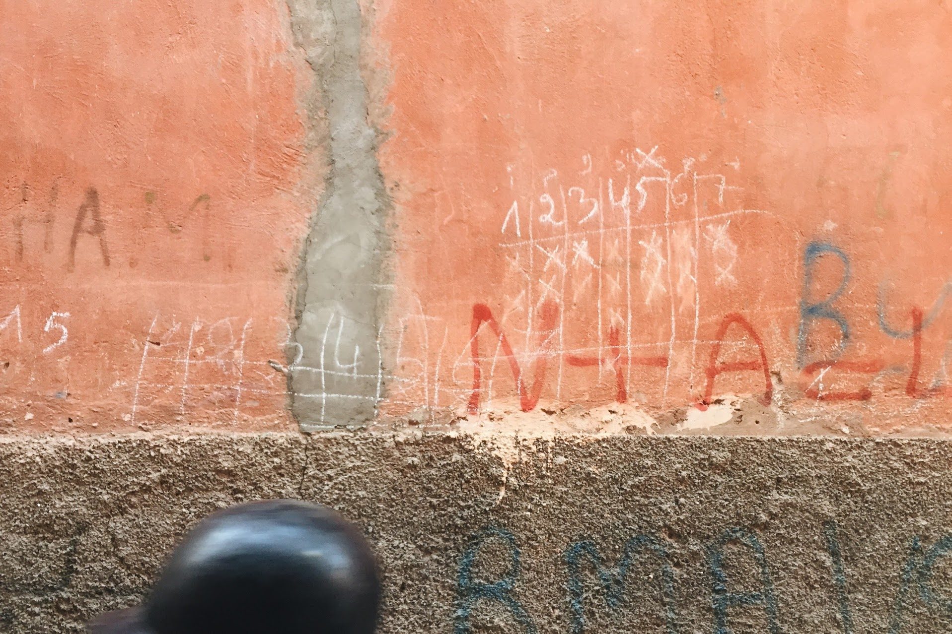 Terracotta wall, scratched marks
