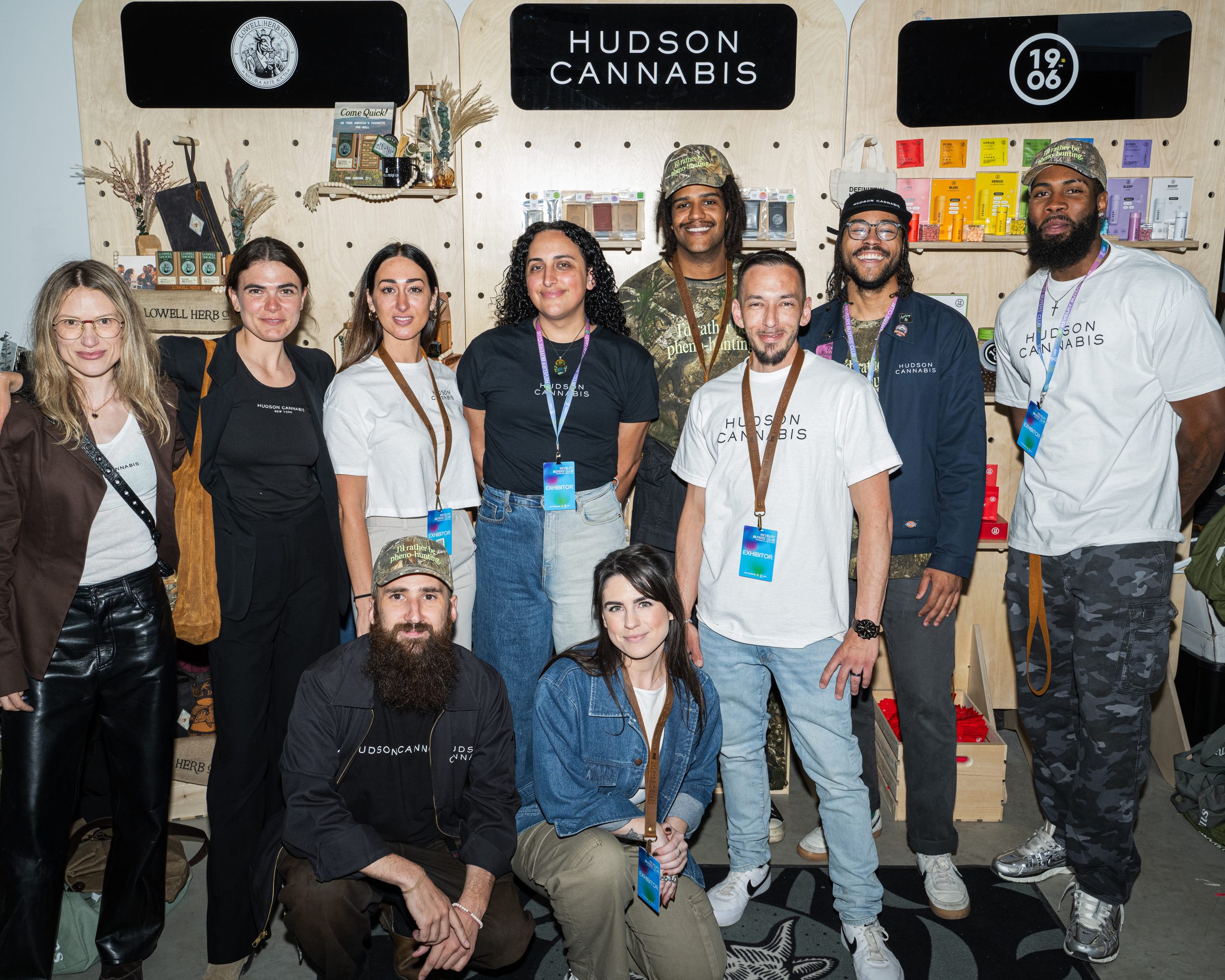 Team at the Revelry booth — plywood, pegboard, product at hand
